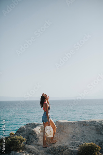 Young woman in bikini walki...