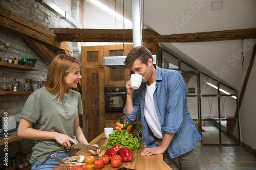 Loving young couple cutting...