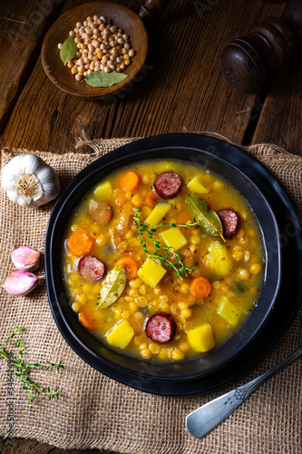 Rustic pea soup with bacon and sausages