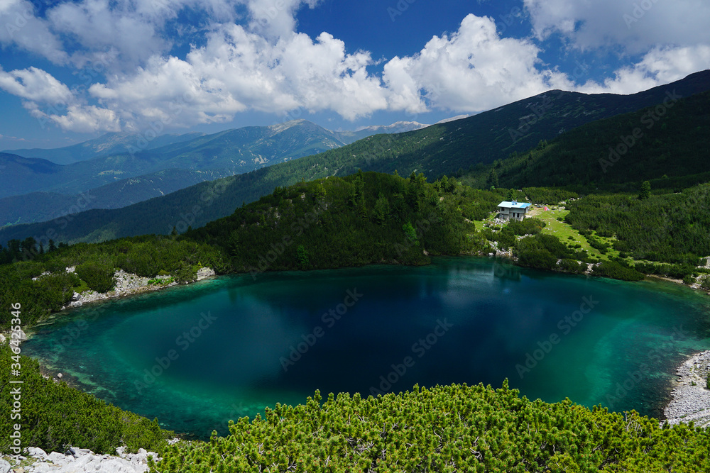 View towards Sinanitsa lake and refuge from the peak in Pirin mountain National park in Bulgaria
