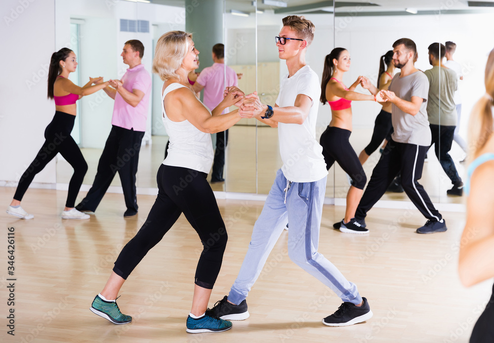 Fototapeta premium Dancing couples learning salsa at dance class
