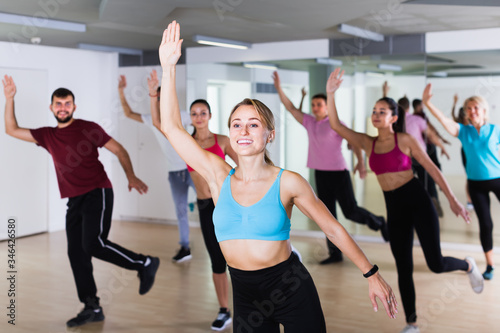 positive people posing in fitness studio