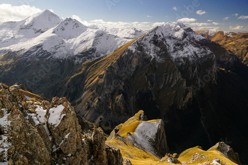 Golden grass alpine pastures below the snow covered peaks of Sar planina mountain in North Macedonia 