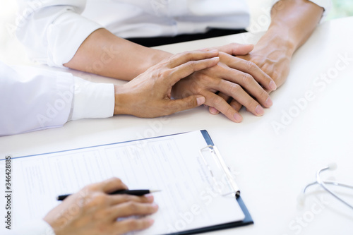 Doctor hold patient hand in hospital.