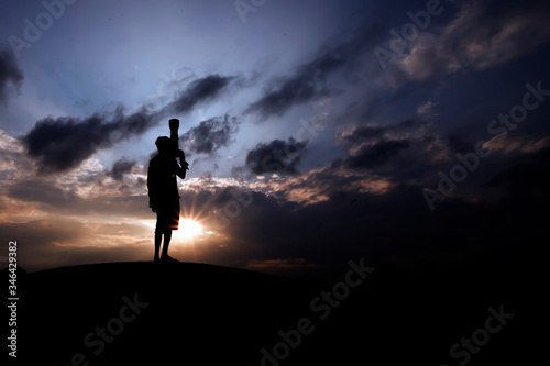 silhouette of a photographer in the sunset