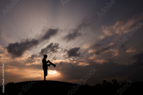 silhouette of a photographer in the sunset