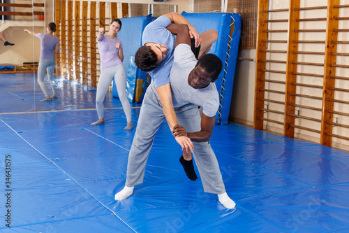 Two men practicing self defense techniques