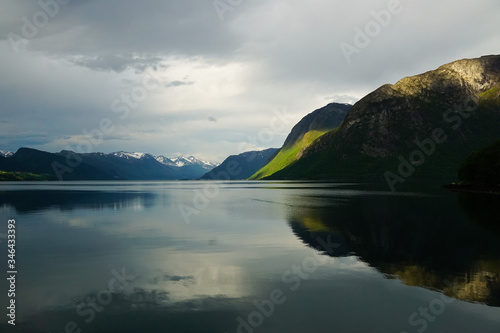 Reflections of mountains and peaks with a rainbow in the waters of Romsdalsfjord in Norway photo