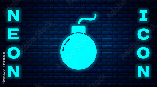 Glowing neon Bomb ready to explode icon isolated on brick wall background. Vector Illustration