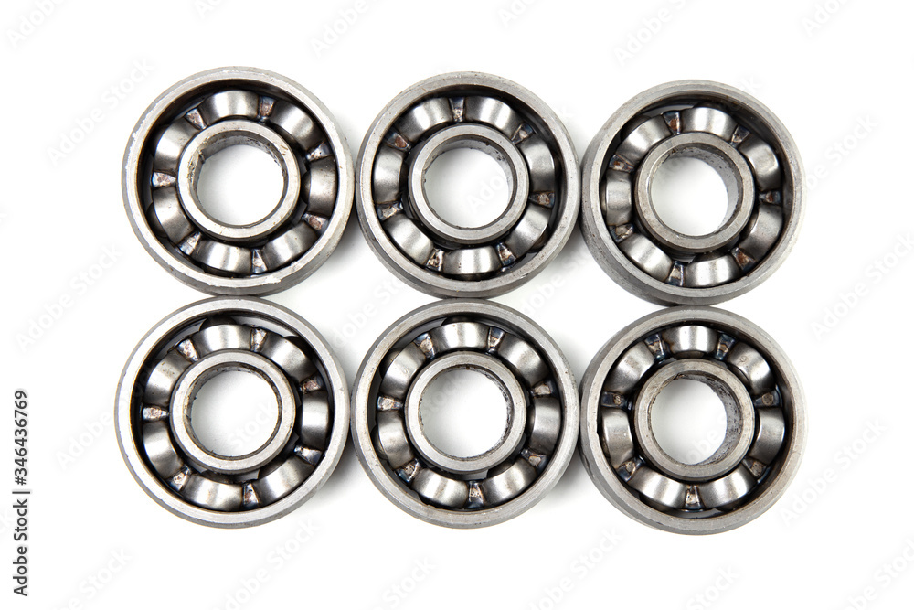 Top view Set of various metal rolling bearing spare part of mechanical on white background. Top view Set of various metal rolling bearing spare part of mechanical on white background.