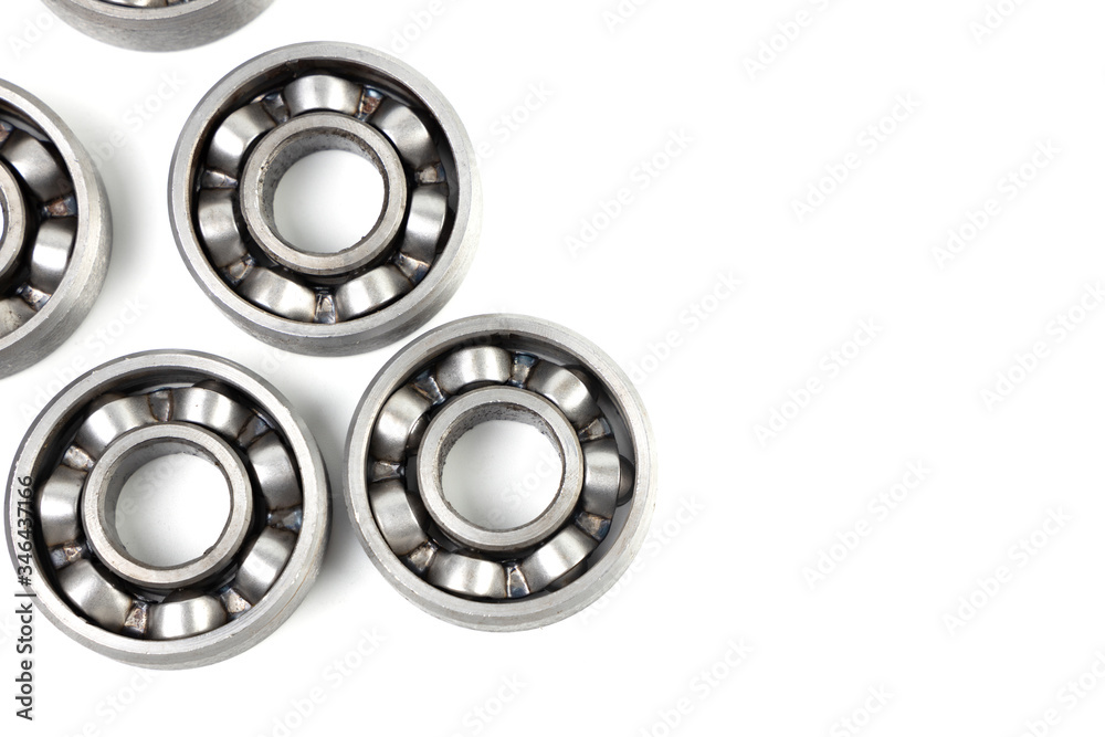 Top view Set of various metal rolling bearing spare part of mechanical on white background. Have copy space. Top view Set of various metal rolling bearing spare part of mechanical on white background. Have copy space.