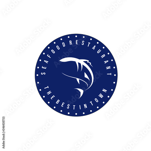 Simple design of seafood restaurant logo or fish suppliers logo with fish silhouette in blue circle with text isolated on white background