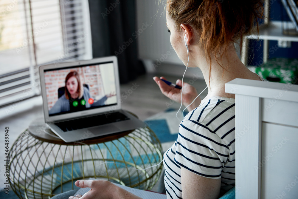 Confused woman while having video conference at home.