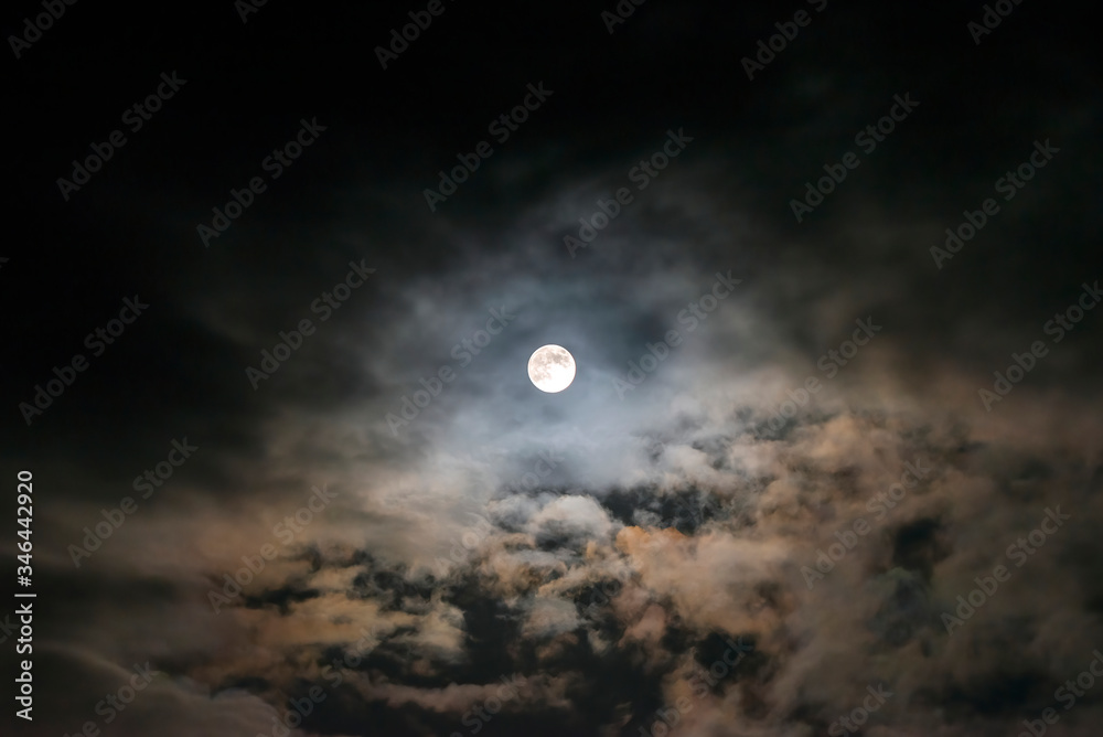 The Flower Moon shining bright in the cloudy sky, 7/5/2020 , Cornwall, UK The Flower Moon shining bright in the cloudy sky, 7/5/2020 , Cornwall, UK