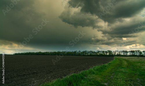 Storm And Rain Above Countryside Rural Field Or Meadow Landscape 