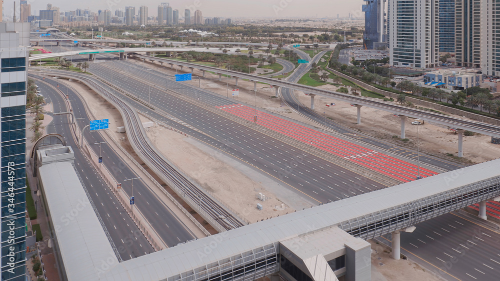 Fototapeta premium Aerial view of empty highway and interchange without cars in Dubai