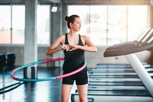 Beautiful Caucasian Sport Woman Workout Exercising with a Hula Hoop in Gym - Lifestyle and Healthcare Concept