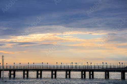 Empty sea pier without people at sunset.