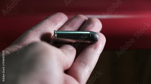 colt 45 bullet in hand photo