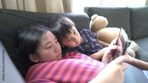 A little boy and sister playing tablet at home