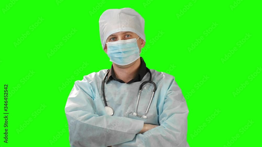 Scientist medic dressed in a surgical gown wears clothes for the neck stetoskop . Video on Chromakey. Scientist medic dressed in a surgical gown wears clothes for the neck stetoskop . Video on Chromakey.