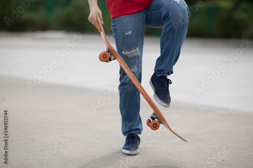 Skateboarder legs skateboarding at outdoors