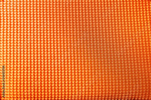 Textured orange fabric as background, closeup view