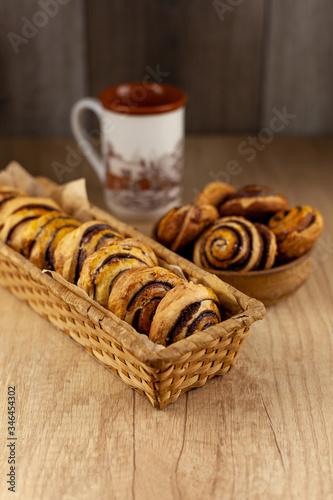 Round homemade cookies on the table. Striped cookies with cocoa and cinnamon. Appetizing rolls for a cup of coffee for breakfast. Wooden background in place for text. Food and drink.
