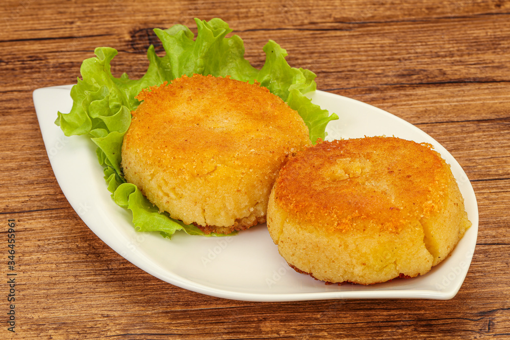 Vegan cuisine - Potato cutlet in the plate Vegan cuisine - Potato cutlet in the plate