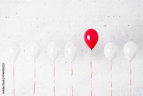 Quadro em tela Unique red balloon among another on white background