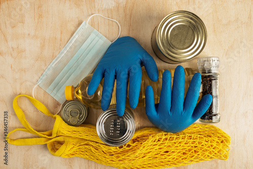 medical protection against covid-19 virus and long-term storage products on a light wooden background