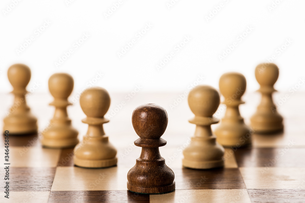 Selective focus of brown pawn among another on chessboard isolated on white Selective focus of brown pawn among another on chessboard isolated on white