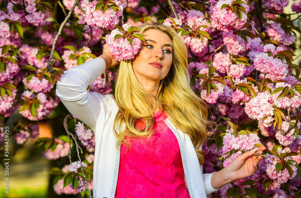 Sakura season. Sakura tree blooming. Pink mood. Spring fashion collection. Woman spring flower sakura bloom background. Blonde woman in garden. Gorgeous girl. Girl cherry flower blossom. Femininity Sakura season. Sakura tree blooming. Pink mood. Spring fashion collection. Woman spring flower sakura bloom background. Blonde woman in garden. Gorgeous girl. Girl cherry flower blossom. Femininity