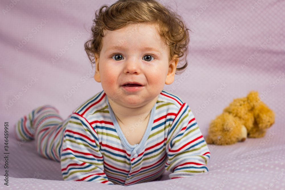 Little smiling boy on the bed. Child at home. Little smiling boy on the bed. Child at home.