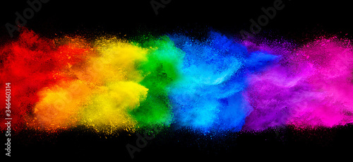 colorful rainbow holi paint color powder explosion garland banner isolated  dark black wide panorama background. peace rgb beautiful party concept photo