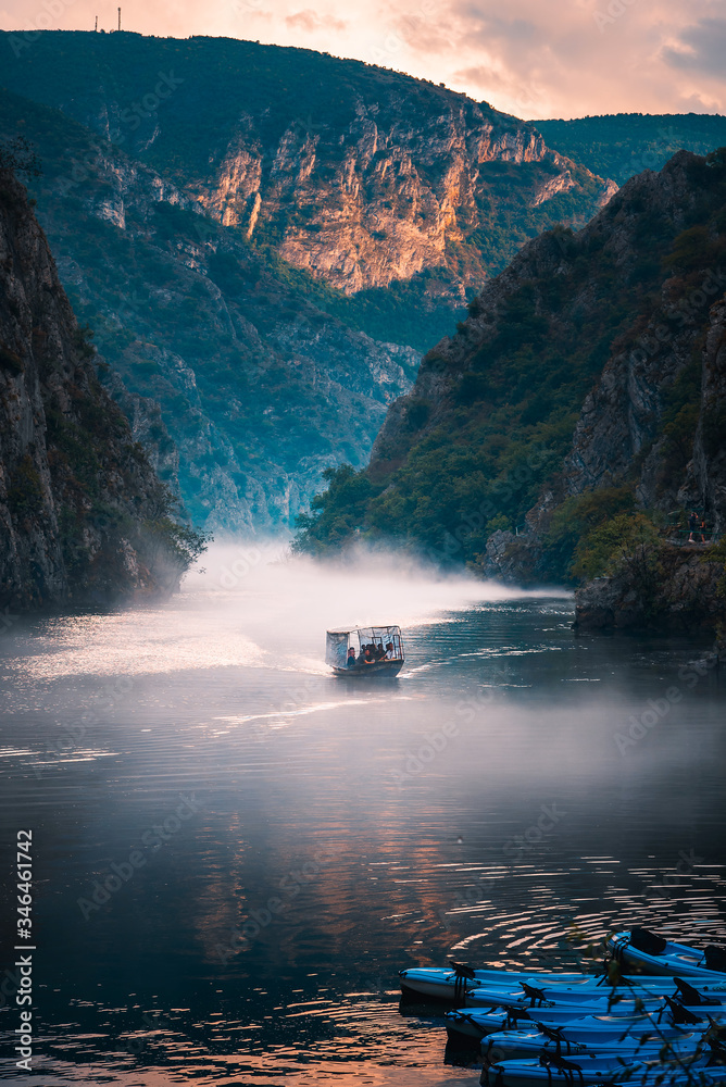 Canyon Matka near Skopje with people kayaking and amazing foggy scenery - obrazy, fototapety, plakaty 