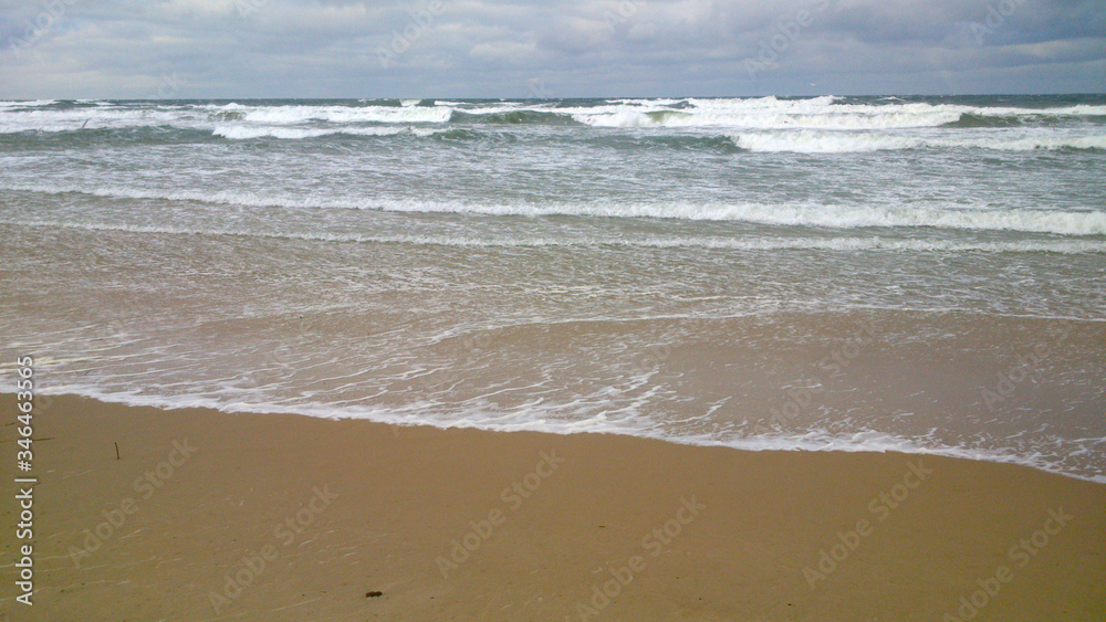 Sea beach on a cloudy day - big waves
