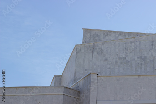 The building is against the blue sky. Urban architecture. Minimalism.