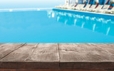 Wooden deck near swimming pool outdoors on sunny day. Space for text