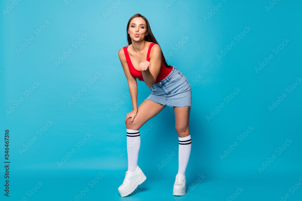 Full length photo of charming romance trendy girl lady hold hand send air kiss her boyfriend attract ideal perfect guy wear legs red tank-top white singlet isolated over blue color background Full length photo of charming romance trendy girl lady hold hand send air kiss her boyfriend attract ideal perfect guy wear legs red tank-top white singlet isolated over blue color background