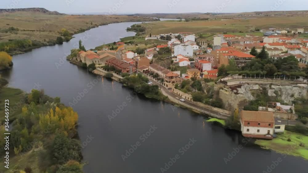 Aerial shot zooming in on rural riverside town Aerial shot zooming in on rural riverside town