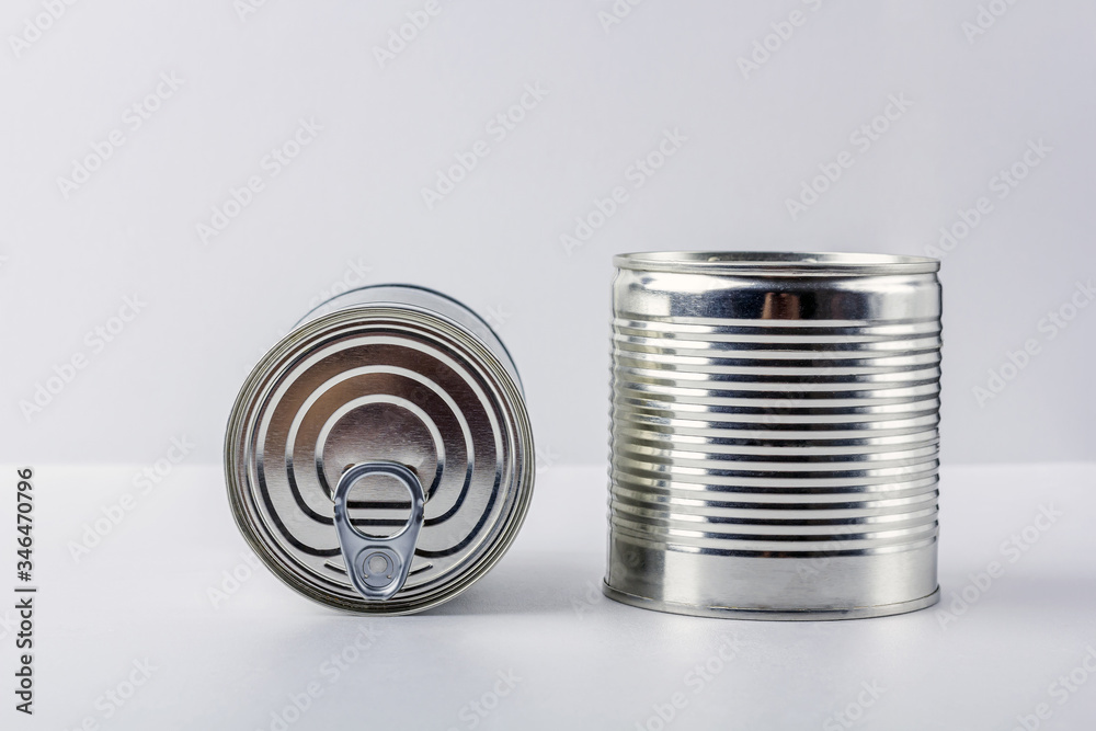 Two tin can (canned food) on white background. Food supplies during coronavirus quarantine and self-isolation. Food delivery, donation, volunteer support. Copy space for text Two tin can (canned food) on white background. Food supplies during coronavirus quarantine and self-isolation. Food delivery, donation, volunteer support. Copy space for text