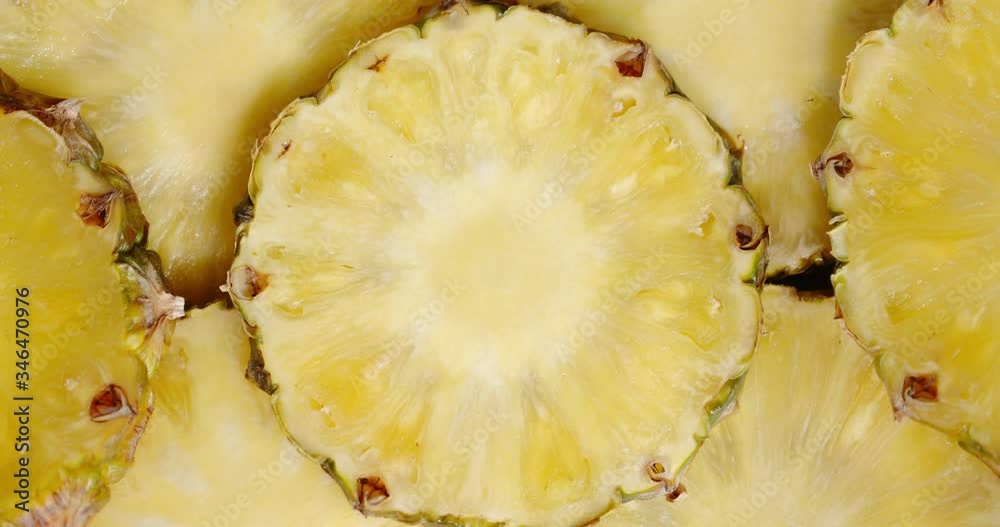 Round slices of ripe pineapple slowly rotate. Round slices of ripe pineapple slowly rotate.