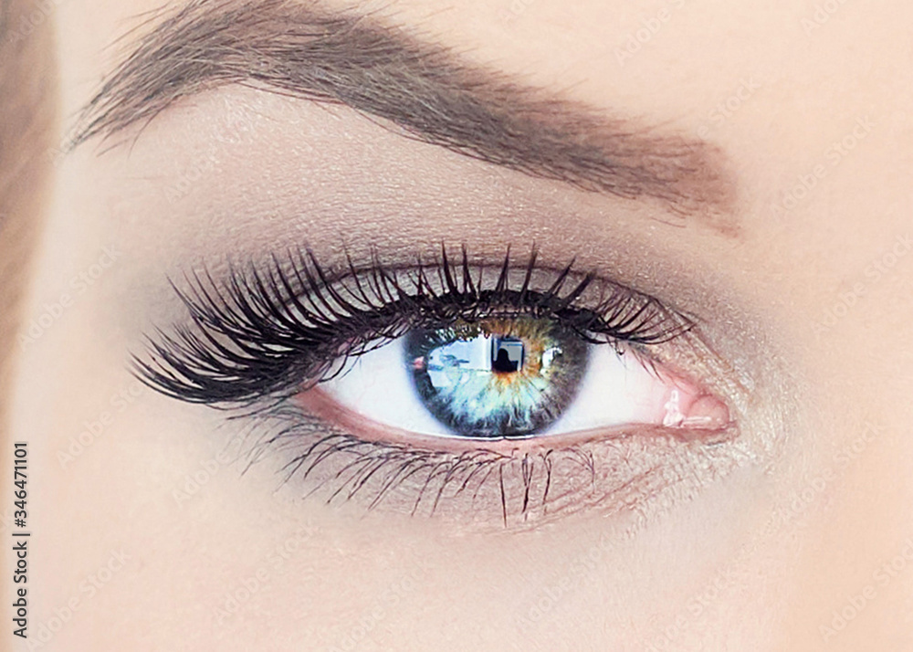 Obraz premium Professional makeup artist working with beautiful young woman. bright blonde model with african pigtails on a white background