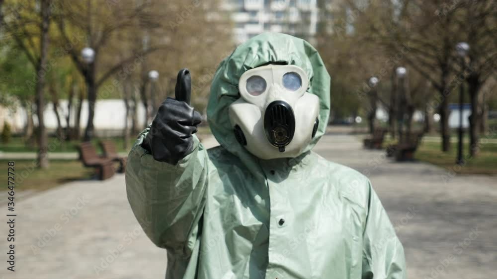 Man in protective suit shows different signs with close-up fingers Man in protective suit shows different signs with close-up fingers