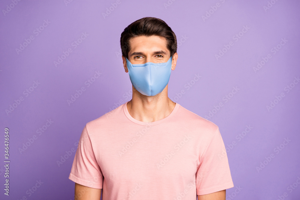 Closeup portrait of attractive glad content brunet guy wear pink t-shirt protection mask on face isolated over violet purple lilac pastel color background Closeup portrait of attractive glad content brunet guy wear pink t-shirt protection mask on face isolated over violet purple lilac pastel color background