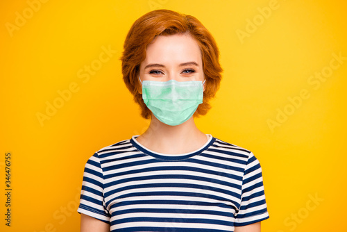 Closeup photo beautiful amazing lady kindhearted easy-going overjoyed wearing casual striped white blue t-shirt protection facial mask isolated yellow bright vibrant vivid background