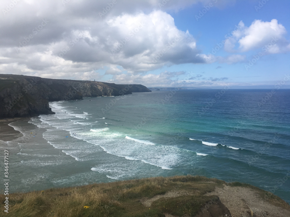 cliffs of Cornwall with turquoise sea and gentle waves on a cloudy day cliffs of Cornwall with turquoise sea and gentle waves on a cloudy day