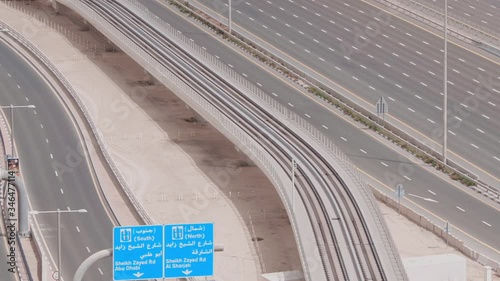 Aerial view of empty highway and interchange in Dubai after epidemic lockdown. Cityscapes with disappearing traffic on streets. Sheikh Zayed road near Dubai Marina and lanes crossroads without cars photo