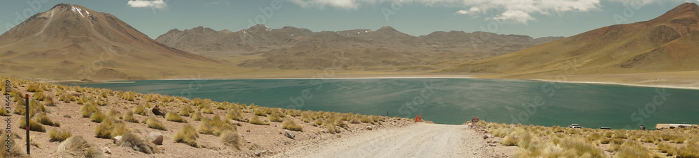 Panoramic surroundings and way to Miscanti Lagoon. Flamingos National Reserve Conaf. San Pedro de Atacama, Antofagasta - Chile. Desert. Andes Range & Route 23. Panoramic surroundings and way to Miscanti Lagoon. Flamingos National Reserve Conaf. San Pedro de Atacama, Antofagasta - Chile. Desert. Andes Range & Route 23.